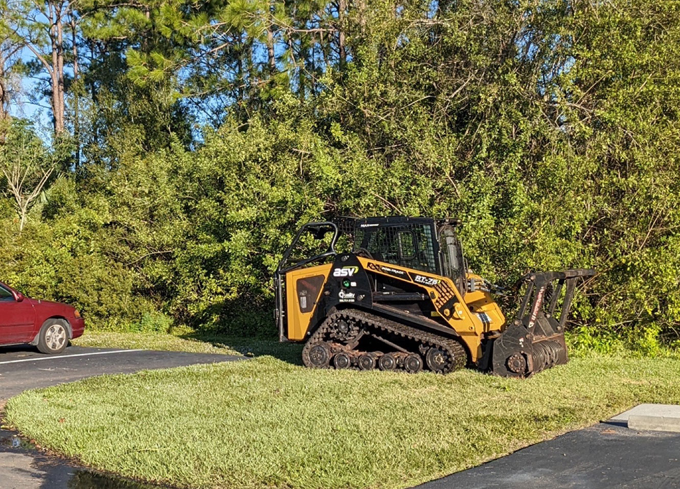 a dozer parked in front of a ton of brush, right before clearing it all